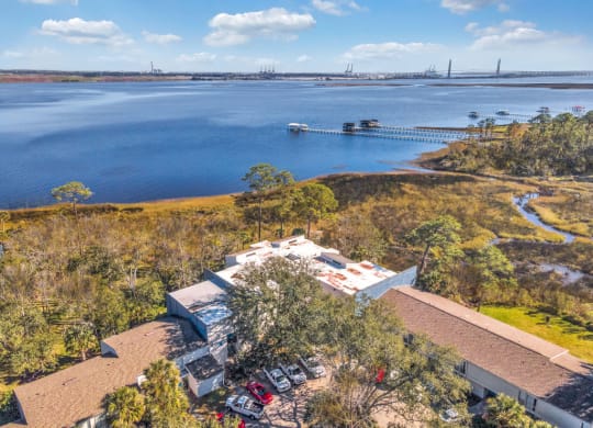 an aerial view of a house near a body of water