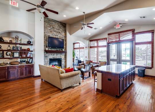 a living room with a fireplace and a kitchen