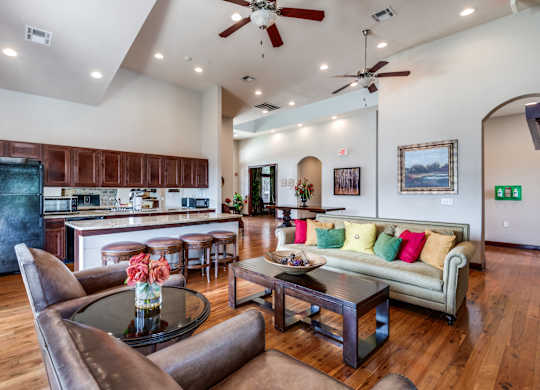 a living room with a kitchen and a couch and a table