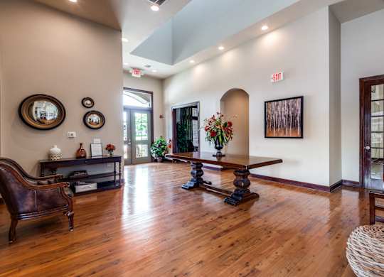 a living room with a hard wood floor and a table