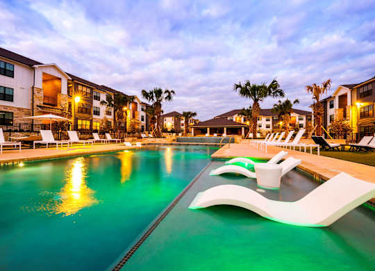 A swimming pool with a greenish tint and a white design on the side.
