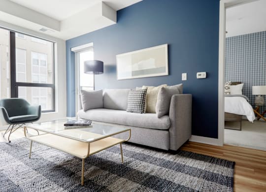 a living room with blue walls and a couch and a coffee table