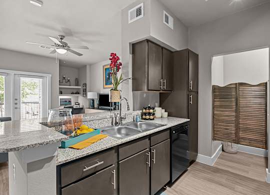 an open kitchen with stainless steel appliances and granite counter tops