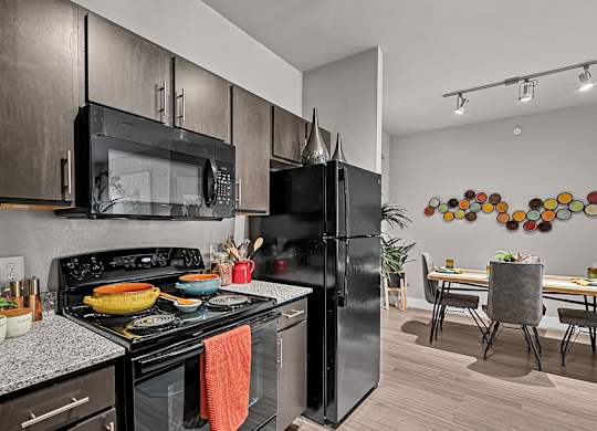 spacious kitchen and dining area at the district flats apartments in lenexa