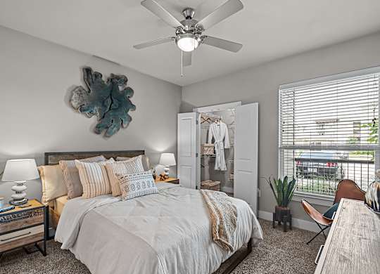 a bedroom with a large bed and a ceiling fan