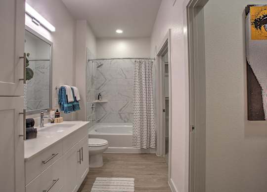 A bathroom with a white counter and a white toilet.