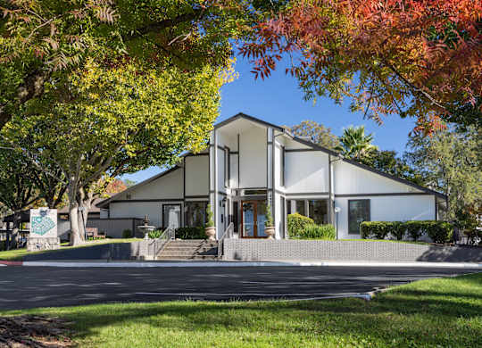 A modern house with a white exterior and a large front porch.