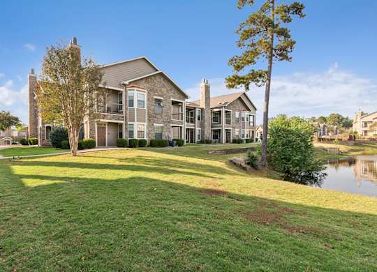 A large house with a green lawn in front.