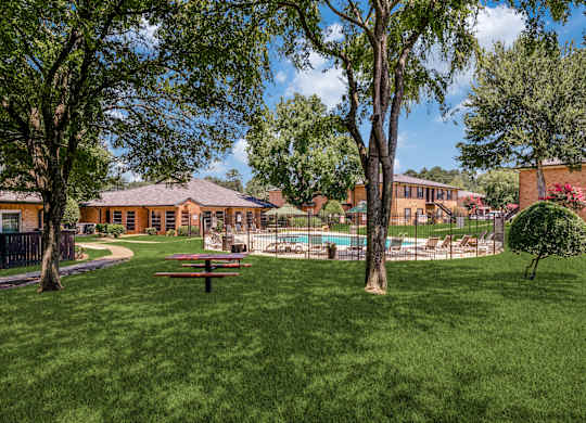 a backyard with a picnic table and a pool