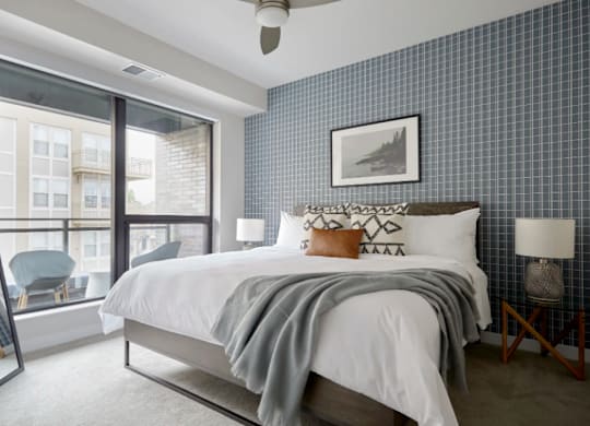 a bedroom with a large bed and a large window