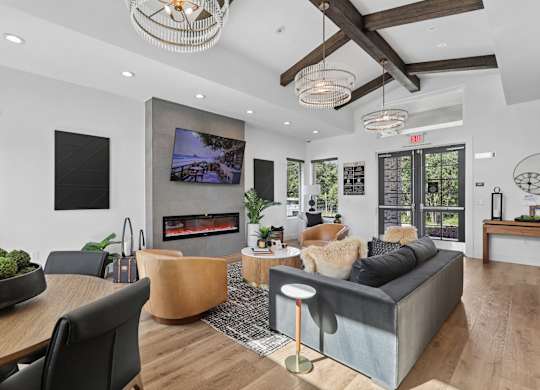 A modern living room with a fireplace and a flat screen TV.