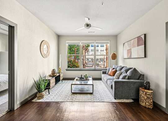 the living room of an apartment with a couch and a coffee table