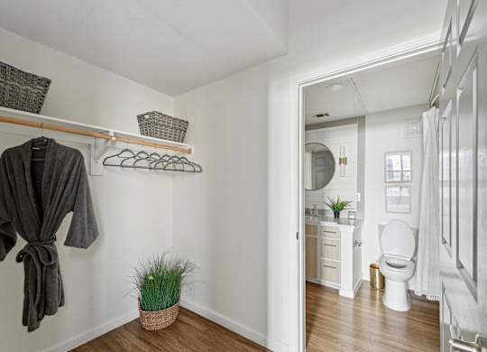 A bathroom with a toilet, sink, and a mirror.