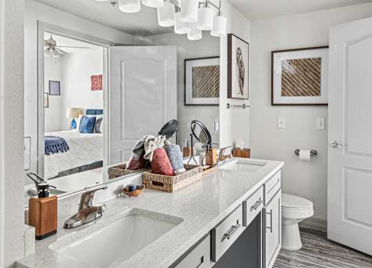 A bathroom with a white sink and a mirror.