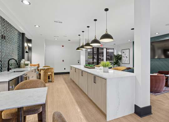 A modern kitchen with a white island and wooden floors.