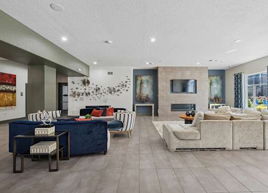 A modern living room with a blue sofa and a white couch.