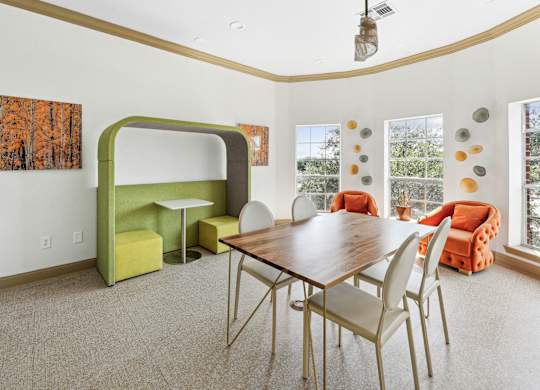 A dining room with a wooden table and chairs.