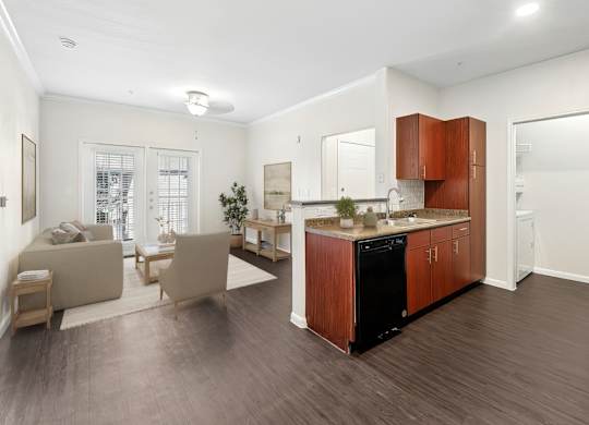 A modern kitchen with wooden cabinets and a black dishwasher.