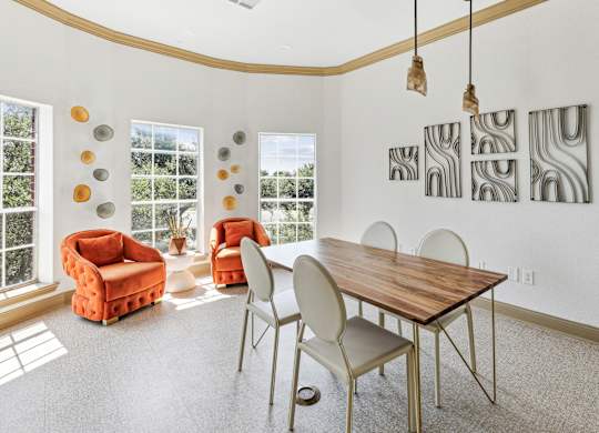 A dining room with a wooden table and chairs.