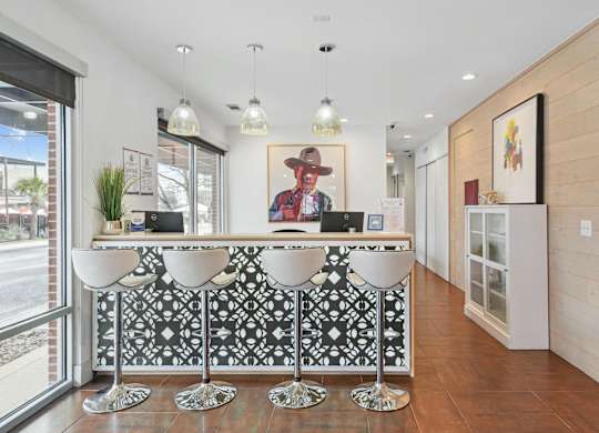 A reception area with a black and white patterned bar.