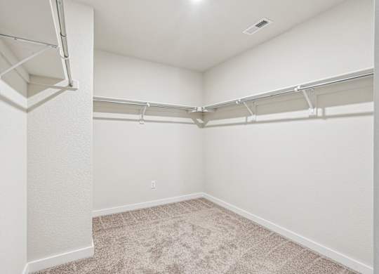 A white room with a carpeted floor and white walls.