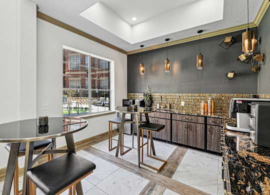 A modern kitchen with a round table and bar stools.