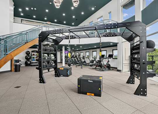 A gym with a TRX suspension trainer hanging from the ceiling.