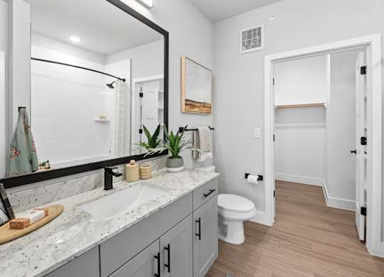 A bathroom with a white toilet and a sink.