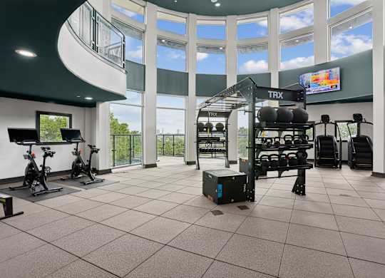 A gym with a TRX suspension trainer and stationary bikes.