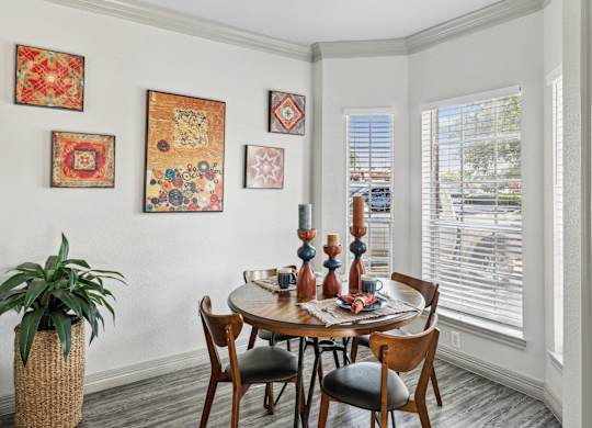 A dining room with a round table and chairs.