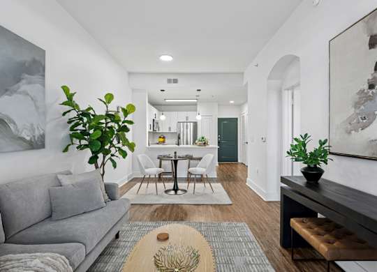 A living room with a grey couch and a wooden coffee table.