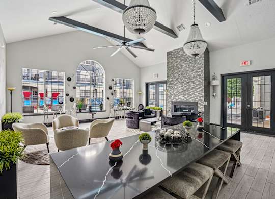 A modern dining room with a glass table and chairs.