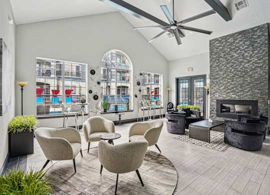 A modern living room with a fireplace and a view of a balcony.