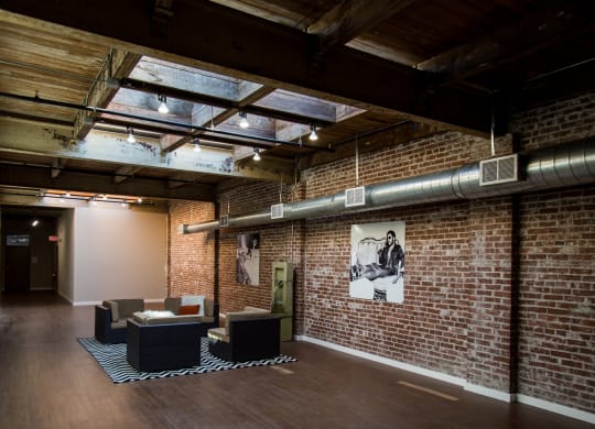 a room with a brick wall and a glass ceiling
