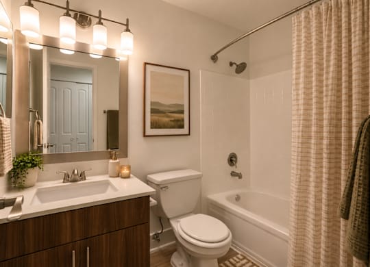 A bathroom with a white toilet, a white sink, a white bathtub, a white shower curtain, a white towel, a white plant, a white vase, a white mirror, a white wall, a