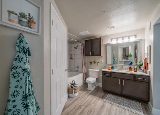 a bathroom with a white toilet next to a bathtub