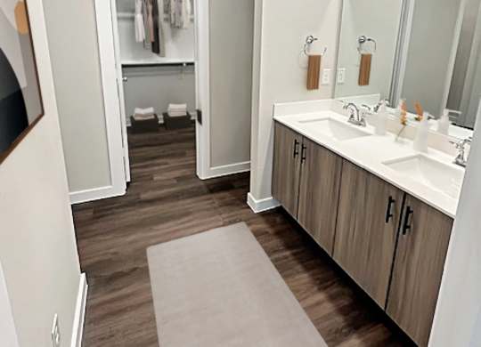 A bathroom with a white sink and a mirror.