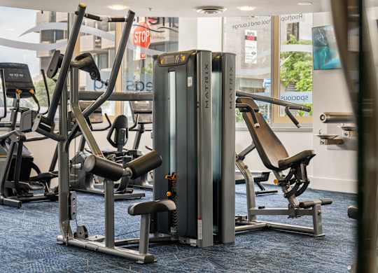 a row of exercise machines in a gym