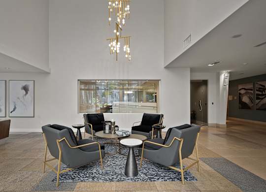 a living room with chairs and a table and a large window