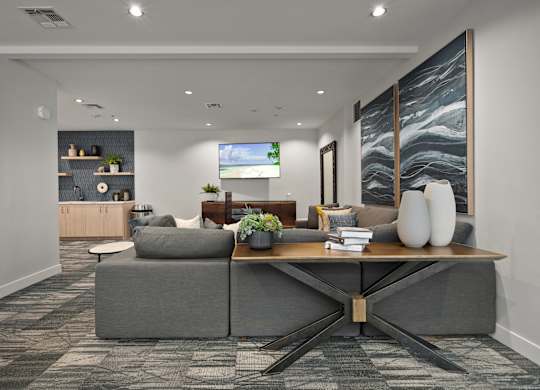 a living room with a gray couch and a wooden table