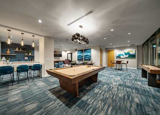 play a game of pool in our game room at our apartments