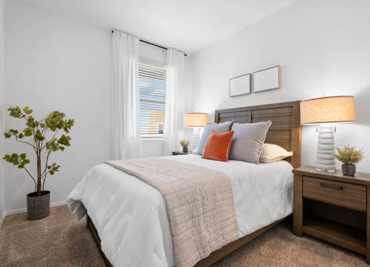 a bedroom with a large bed and a window