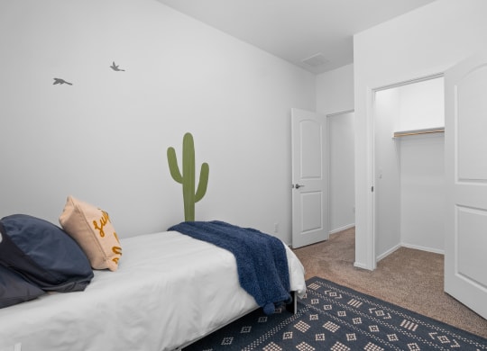 a bedroom with a bed and a cactus on the wall