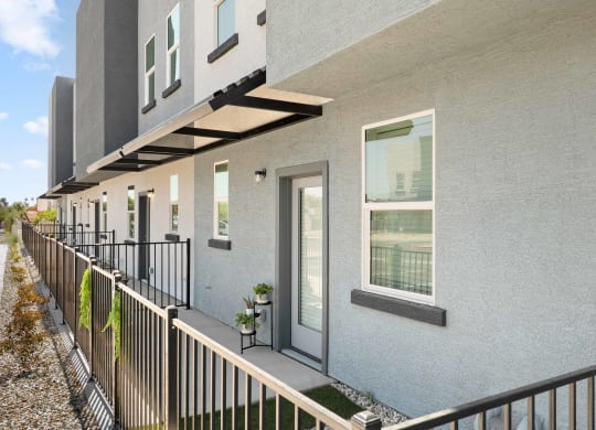 a row of townhomes with balconies on the side of a building