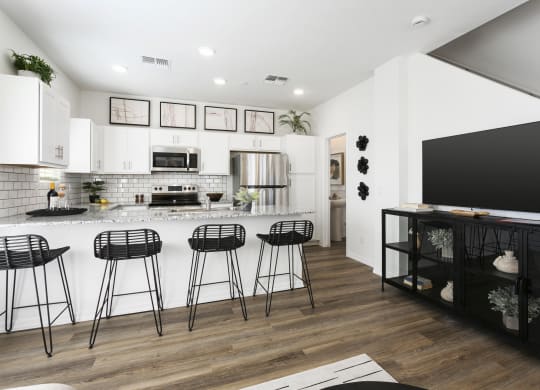 a living room with a kitchen and a tv