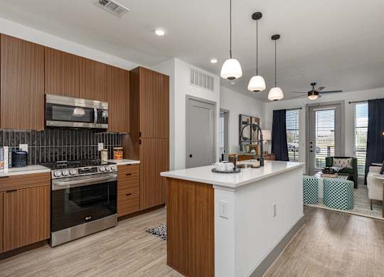 A modern kitchen with wooden cabinets and a white island.