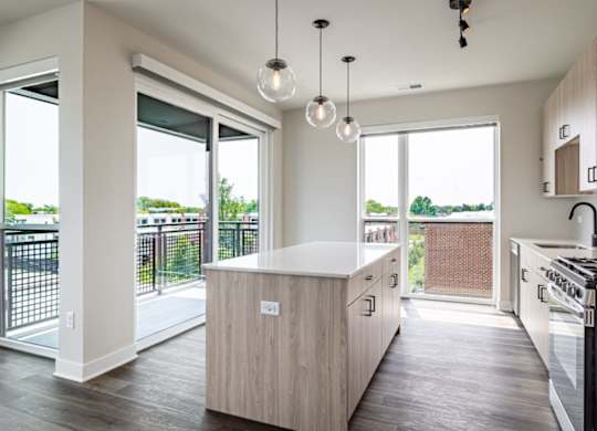 A modern kitchen with a wooden island and stainless steel appliances.