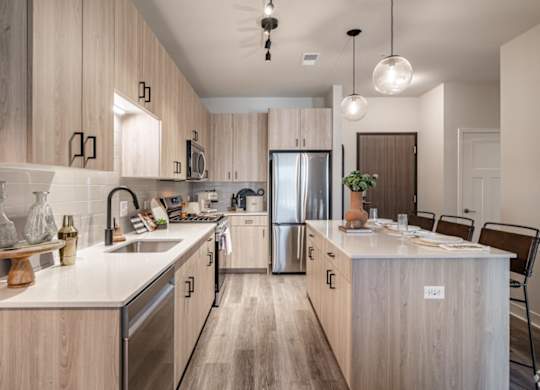 A modern kitchen with wooden cabinets and stainless steel appliances.