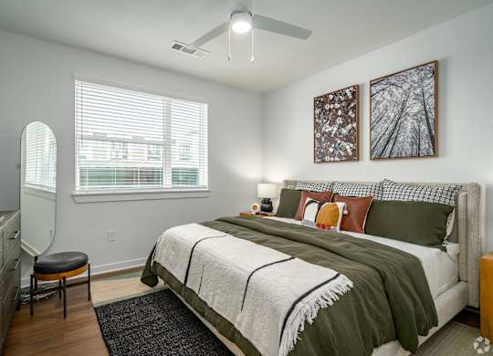 a bedroom with a bed and a ceiling fan
