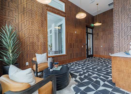A reception area with a wooden wall and a black and white floor.